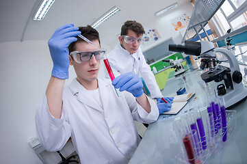 Image showing Group of young medical students doing research