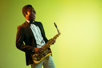 Image showing Young african-american jazz musician playing the saxophone