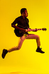 Image showing Young african-american jazz musician playing the guitar