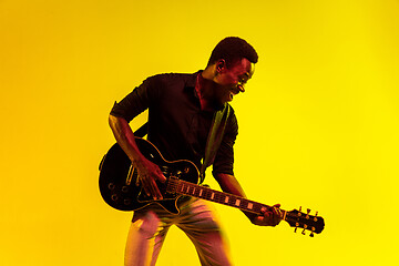 Image showing Young african-american jazz musician playing the guitar