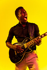 Image showing Young african-american jazz musician playing the guitar