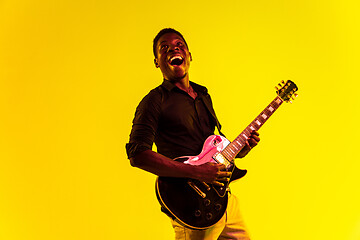 Image showing Young african-american jazz musician playing the guitar