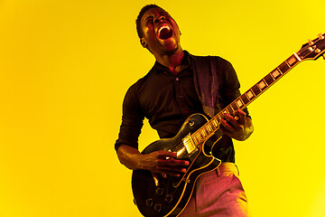 Image showing Young african-american jazz musician playing the guitar