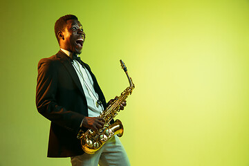 Image showing Young african-american jazz musician playing the saxophone