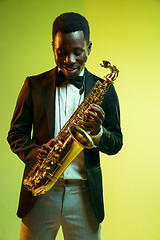 Image showing Young african-american jazz musician playing the saxophone