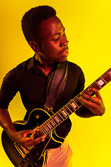 Image showing Young african-american jazz musician playing the guitar