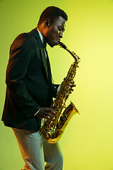 Image showing Young african-american jazz musician playing the saxophone