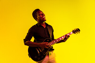 Image showing Young african-american jazz musician playing the guitar