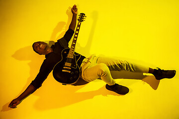 Image showing Young african-american jazz musician playing the guitar