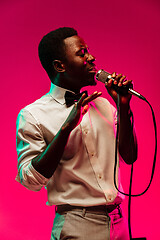 Image showing Young african-american jazz musician singing a song