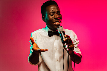 Image showing Young african-american jazz musician singing a song