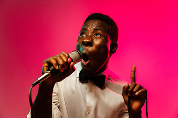 Image showing Young african-american jazz musician singing a song