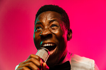 Image showing Young african-american jazz musician singing a song