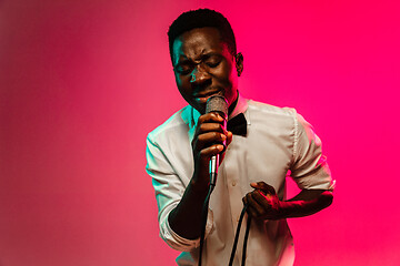 Image showing Young african-american jazz musician singing a song