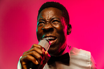 Image showing Young african-american jazz musician singing a song