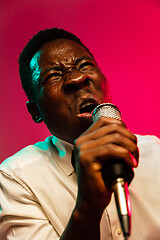 Image showing Young african-american jazz musician singing a song