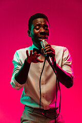 Image showing Young african-american jazz musician singing a song