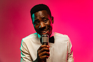 Image showing Young african-american jazz musician singing a song