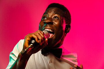 Image showing Young african-american jazz musician singing a song