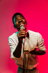 Image showing Young african-american jazz musician singing a song