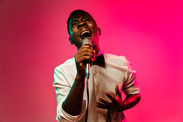 Image showing Young african-american jazz musician singing a song