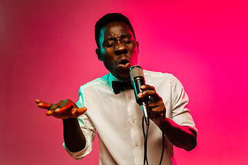 Image showing Young african-american jazz musician singing a song