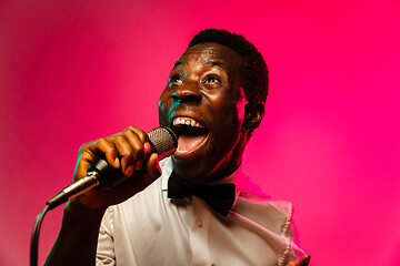 Image showing Young african-american jazz musician singing a song