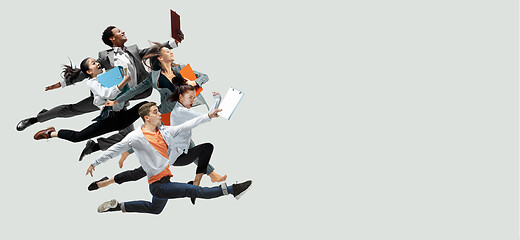 Image showing Office workers jumping isolated on studio background