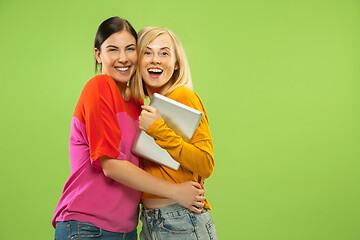 Image showing Portrait of pretty girls isolated on green studio background