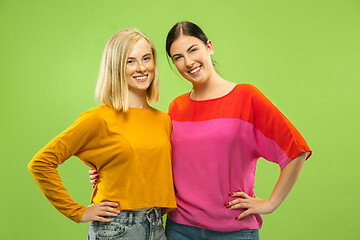 Image showing Portrait of pretty girls isolated on green studio background