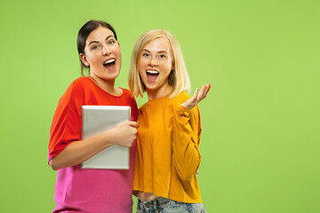 Image showing Portrait of pretty girls isolated on green studio background