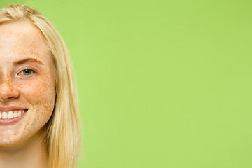 Image showing Caucasian young woman\'s close up portrait on green background