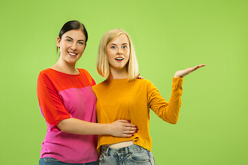 Image showing Portrait of pretty girls isolated on green studio background