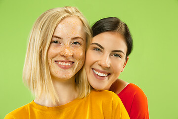 Image showing Portrait of pretty girls isolated on green studio background