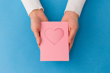 Image showing hands holding greeting card with heart