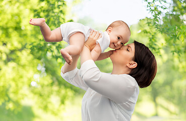 Image showing happy mother kissing little baby daughter