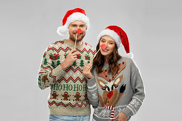 Image showing couple with christmas party props in ugly sweaters