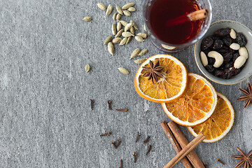 Image showing hot mulled wine, orange slices, raisins and spices