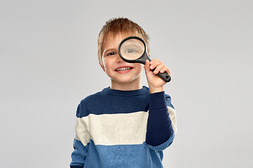 Image showing little boy looking through magnifying glass