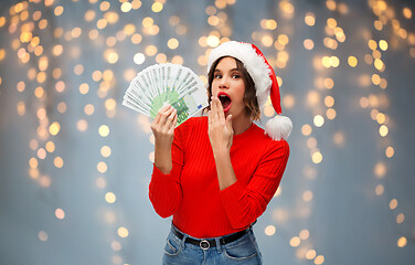 Image showing woman in santa hat with money on christmas