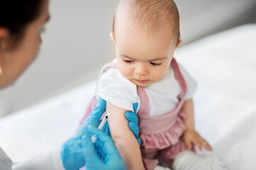 Image showing doctor making vaccine for baby patient at clinic