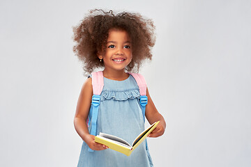 Image showing happy little african girl with book and backpack