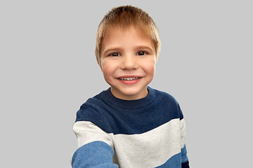 Image showing happy little boy in striped pullover taking selfie