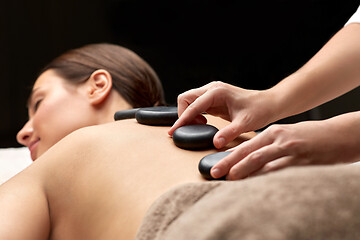 Image showing close up of woman having hot stone massage at spa