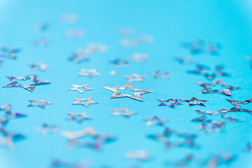 Image showing star shaped confetti decoration on blue background