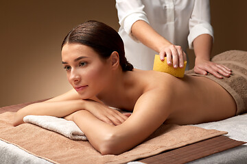 Image showing woman having back massage with sponge at spa