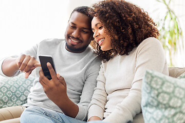 Image showing african american couple with smartphone at home