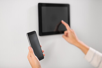 Image showing woman using tablet computer and smartphone