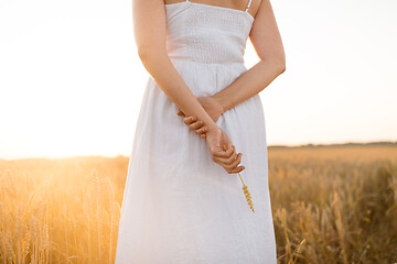 Image showing woman on cereal field holding ripe wheat spickelet