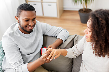 Image showing african american man giving woman engagement ring